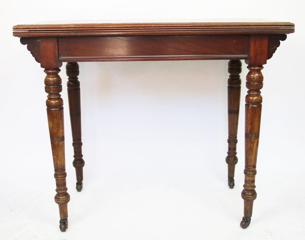 A late Victorian walnut card table, on turned and tapered legs,