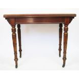 A late Victorian walnut card table, on turned and tapered legs,