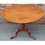A George III mahogany tilt top circular table, with turned column, on tripod base,