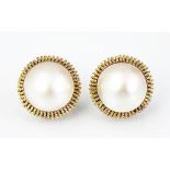 A pair of mabé pearl and yellow metal set stud earrings,