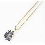A sapphire and diamond set scroll pendant in 9ct yellow gold,