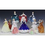 A collection of thirteen Royal Doulton and other bone china figurines, all seconds,