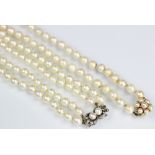 A single strand cultured pearl necklace, with attached pearl set cluster clasp stamped '375',