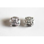 A pair of unusual diamond set stud earrings,