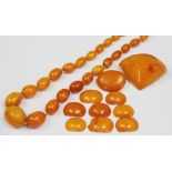 A 'butterscotch' amber bead necklace, the thirty seven graduated beads on knotted string,