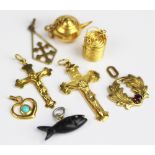 A collection of assorted yellow metal charms, to include; a basket enclosing kettle stamped 14k,