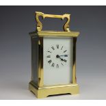A lacquered brass carriage time piece, with Roman numeral dial and back plate stamped ACG,