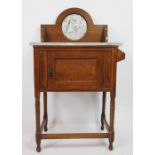 An Edwardian oak wash stand, of small proportions, with grey marble back and top,