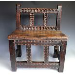 A 17th cenury inspired stool, constructed from old timbers, with carved detailing and solid seat,