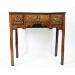 An 18th century walnut low boy, with quarter veneered top, over three drawers, on chamfered legs,