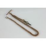 A 9ct yellow gold graduated curb link albert chain, with attached swivel and T bar, 35cm long,