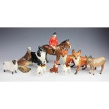A Beswick model of a huntsman, with two beagles and a seated fox,