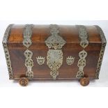 An 18th century style oak barrel top chest, the three plank top with pierced iron strapwork,