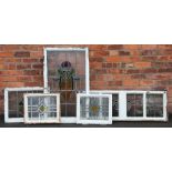 Five Art Nouveau lead and stained glass window panes, the largest 106cm x 65cm,
