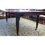 A Regency mahogany extending dining table, with moulded frieze,