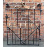 A wrought iron gate, with scroll detailing,