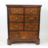 A burr walnut cabinet, modelled as a George III bachelors type chest,