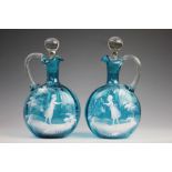 A pair of Victorian Mary Gregory style decanters and stoppers,
