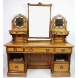 A late 19th century Arts and Crafts golden oak dressing table, the upper section with mirror,
