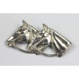 A silver double horses head brooch, D & S, Birmingham 1948, 4.5cm wide, 4.