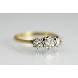 A three stone diamond ring, the three graduated diamonds, each illusion set within white metal,