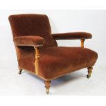 A Victorian walnut open club arm chair in the manner of Howard and Sons,