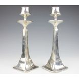 A pair of George V silver candlesticks, Birmingham 1924, tapering stems on rounded square bases,