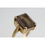 A smokey quartz set dress ring, the large, rectangular cut quartz,