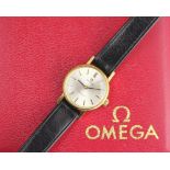 A ladies Omega wristwatch, the circular face with baton dial within yellow metal case,