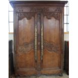 An 18th century French carved oak armoire,