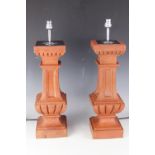 A pair of terracotta table lamps, late 19th century balustrade columns with modern fittings,