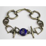 EQUESTRIAN INTEREST: A white metal bracelet, designed as a snaffle,
