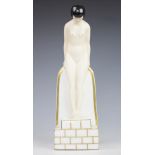 An Art Deco Robj Paris porcelain figure, modelled as an arched nude femme fatale,