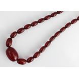A 'cherry' amber graduated single strand bead necklace, formed as forty one beads,