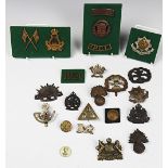 A collection of military cap badges and buttons, including Canada,