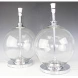 A pair of contemporary clear glass table lamps, each of globular form with chrome fittings,