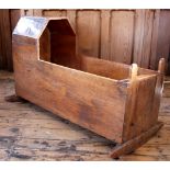 An oak panelled cradle, 18th/19th century, with hood upon two rockers,