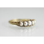 A five stone pearl ring, the five, graduated untested, split pearls,