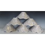 A set of six lamp shades, each of scalloped shape with embroidered detail,