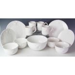 A contemporary dinner service for eight, each piece glazed in white and chicken decorated,