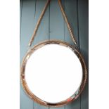 A circular porthole type mirror, with rope border, 56cm diameter,