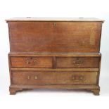An 18th century oak mule chest, in two sections, with hinged coffer top,