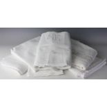 A selection of white textiles and household linens including table cloths,