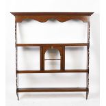 A late Victorian mahogany plate rack, with four shelves around a central alcove,