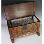 A small French oak coffer, of 17th century design, the front carved with two roundels,