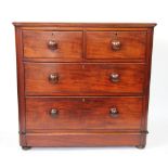 A Victorian mahogany chest, of two short and two long drawers, on bun feet,
