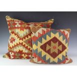 A pair of large Kilim cushions, 60cm H x 60cm W, and a similar smaller example,