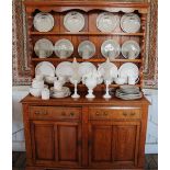 A George III style golden oak dresser, the plate rack with a serpentine cornice,