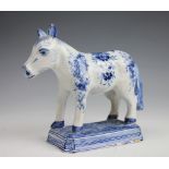 A Delft horse, late 18th/early 19th century, painted in blue with a blossoming floral design,