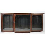 An Edwardian pine and beech breakfront shop display cabinet, with three glazed doors,
